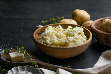 Mushed potatoes top view with raw potatoes and spices