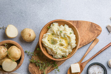 Mushed potatoes top view with raw potatoes and spices