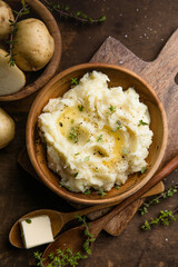 Mushed potatoes top view with raw potatoes and spices
