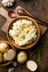 Mushed potatoes top view with raw potatoes and spices