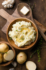 Mushed potatoes top view with raw potatoes and spices