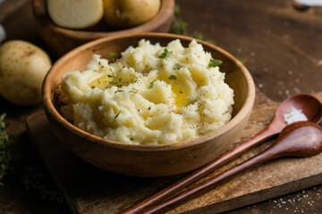 Mushed potatoes top view with raw potatoes and spices