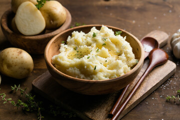 Mushed potatoes top view with raw potatoes and spices