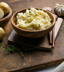 Mushed potatoes top view with raw potatoes and spices