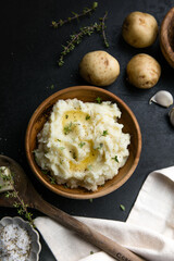 Mushed potatoes top view with raw potatoes and spices