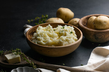 Mushed potatoes top view with raw potatoes and spices