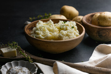 Mushed potatoes top view with raw potatoes and spices