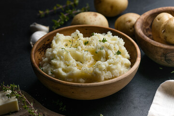 Mushed potatoes top view with raw potatoes and spices