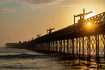 Pier structure at sunset in Pimentel, Peru