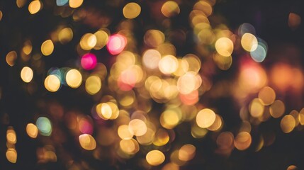 Obraz premium Golden bokeh lights glowing softly on dark background, warm abstract festive texture for celebration or Christmas design