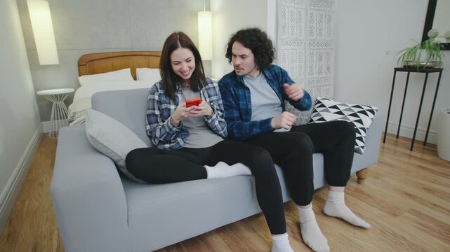 A man snatches his girlfriend s phone while she s texting, sparking a heated argument. The scene captures emotional tension and mistrust in a modern relationship