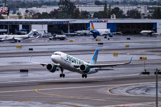Sky Harbor Airport 10-11-2025 Phoenix AZ USAFrontier Airlines Airbus A320Neo N372FR departure from 7L at a rain soaked  Phoenix Sky Harbor Intl. Airport