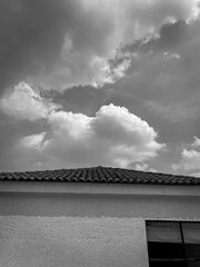 Minimal roof and cloudy sky in black and white
