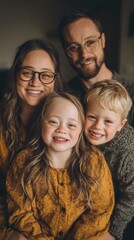 Obraz premium Family portrait captured in a warm, cozy environment, showcasing genuine smiles and bonds. The image reflects love, joy, and connection between family members in a natural setting. 