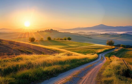 Tuscany road sunrise a winding path to farm on hills, distant misty mountains - Powered by Adobe