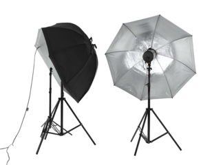 Two studio lighting umbrellas with stands against a black background