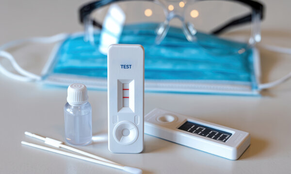 Medical rapid antigen test kit displaying positive result for virus detection.