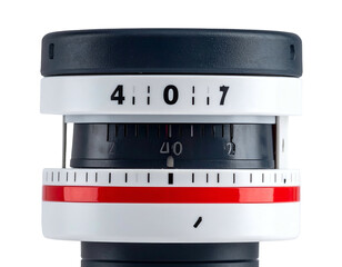 Close-up of a device with rotating dials, numbers, and color bands on a white surface