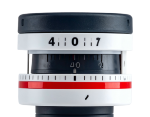 Close-up of a device with rotating dials, numbers, and color bands on a white surface