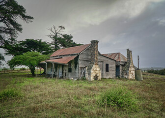 Obraz premium Old wooden farmhouse with a rusty roof and fence in Victoria country, Australia