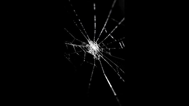 cracks glass fracture effect texture isolated abstract black background. Cracked glass animation, transparent 4K video,
Slow-motion sequence of glass shattering against a black background