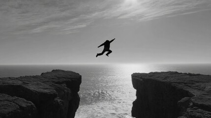 Monochrome Silhouette of Man Jumping Across Chasm Towards Opportunity and Freedom by the Sea