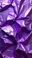 Textured abstract close-up of crumpled, reflective, violet foil