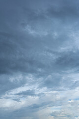 Obraz premium Dense layers of dark and light grey stormy clouds fill the entire sky background