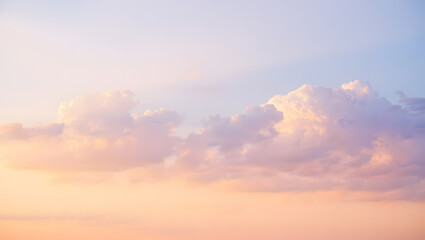 Dreamy pastel sky with soft clouds at sunset creating a serene and peaceful atmosphere