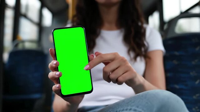 Green Screen young woman hold use phone sitting in bus touch telephone public communication vertical smartphone adult finger chroma urban cellphone application digital scrolling slow motion scene 1