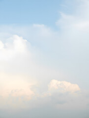 Gentle clouds drift across a pale blue sky, creating a serene and peaceful atmosphere