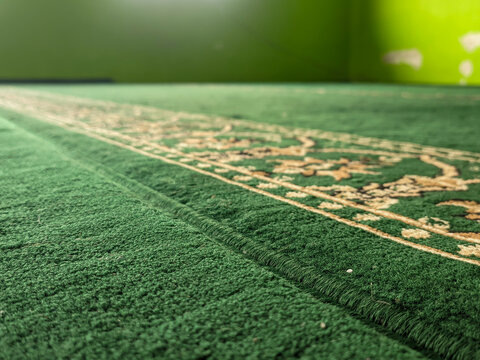 Details of a turquoise mosque carpet with Islamic geometric patterns