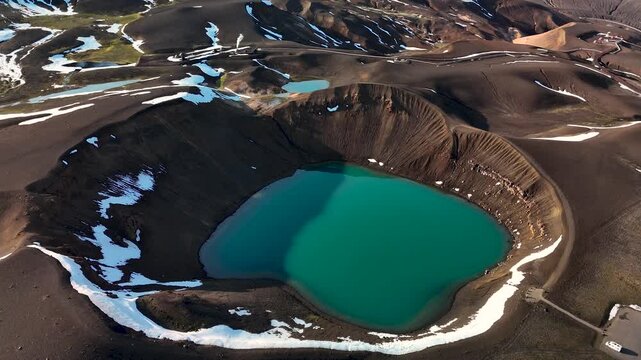 Witness the breathtaking Krafla crater in Iceland, featuring an impressive turquoise lake at its center.