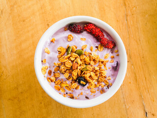Yogurt Granola grains and Almonds bean in bowl on white background. Food for energy breakfast, brunch snack. Healthy ingredients food contains nutrition protein, vitamins. Footage lifestyle restaurant