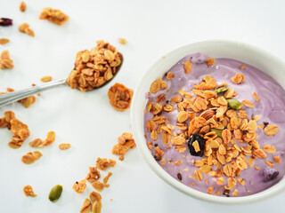 Yogurt Granola grains and Almonds bean in bowl on white background. Food for energy breakfast, brunch snack. Healthy ingredients food contains nutrition protein, vitamins. Footage lifestyle restaurant