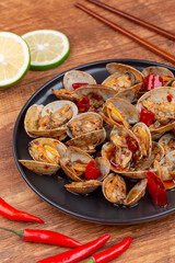 Spicy Stir Fried Clams Served with Gloved Hand