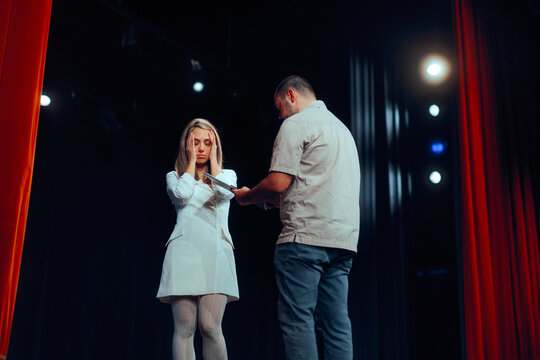 Stressed Actress Receiving Critical Feedback from the Director.  Play conductor giving  harsh criticism over the performance of the talent  