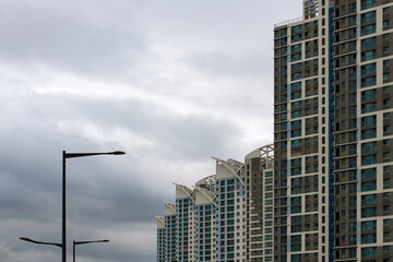 Fototapeta premium tall residential buildings and lighthouses against the overcast sky