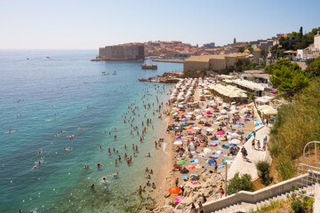 Dubrovnik beach on summer day with historic city