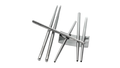 Silver metal chopsticks rest with sticks balanced on holder