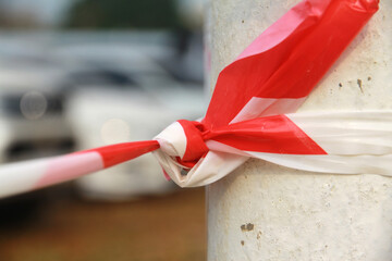 A red and white plastic rope, a danger zone symbol.