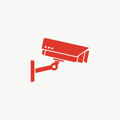 Red security camera icon mounted on a wall, symbolizing surveillance, safety, and monitoring in a minimalist graphic style.