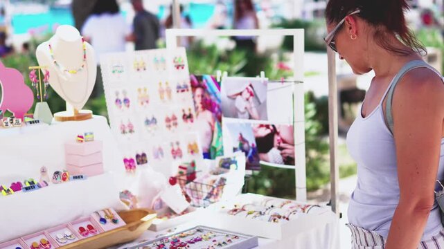 Woman shopping for jewelry at outdoor market in Split