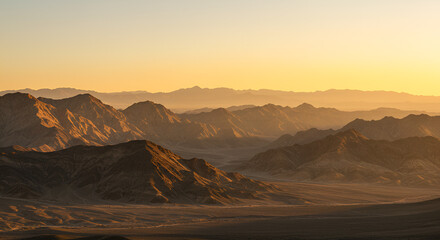Scenic Mountain Range Landscape at Sunset with Layers of Peaks and Warm Light