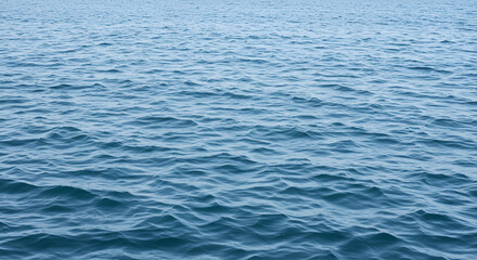 Serene expanse of the ocean featuring gentle waves and a calming blue hue