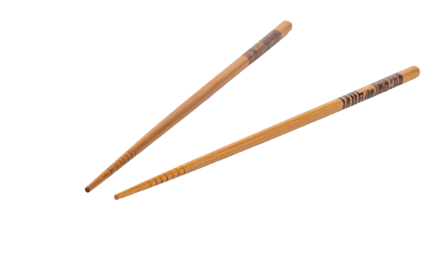 Pair of tan chopsticks with dark decorative banding on black