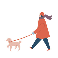 犬の散歩をする冬服を着た女性