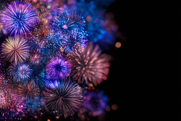 Fototapeta premium A vibrant display of fireworks exploding with blue purple and pink hues against a dark backdrop