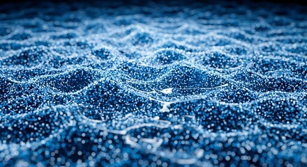 Abstract background of a dynamic, undulating liquid surface with luminous blue particles.