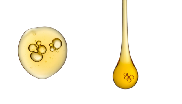 Close-up of yellow liquid droplets with bubbles on a black background